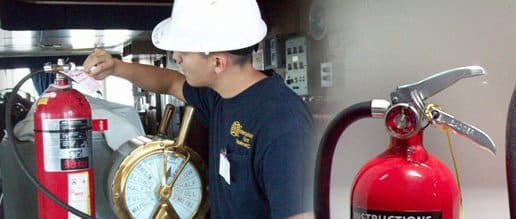 Technician inspecting a fire extinguisher